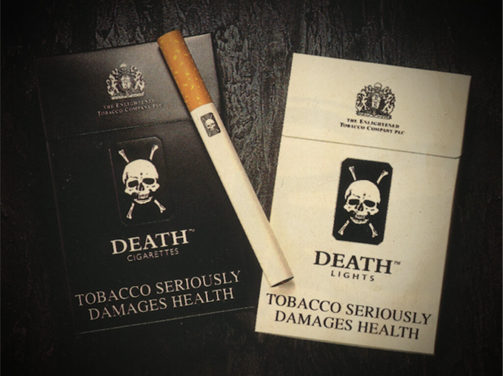 A picture of two packs of cigarettes, each prominently featuing a skull and crossbones. The black box is called Death Cigarettes and the White Box is called Death Lights. There is a large warning at the bottom that reads "TOBACCO SERIOUSLY DAMAGES HEALTH" and a single cigarette shows the skull and crossbones stamped not the paper.